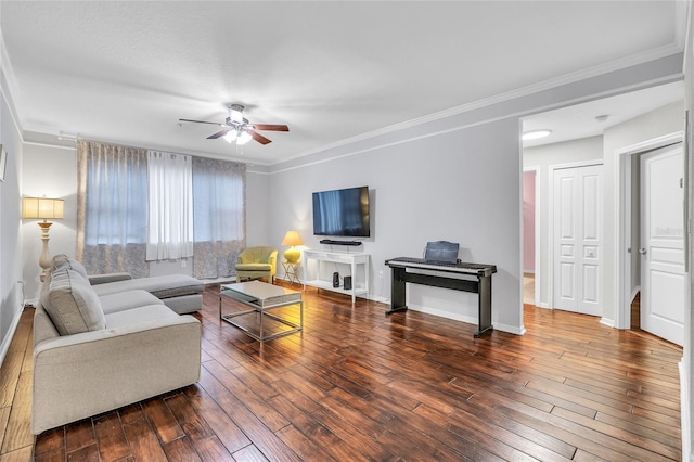 living room with baseboards, wood-type flooring, ceiling fan, and crown molding