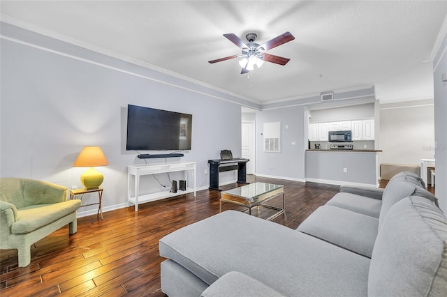 living area with visible vents, dark wood-type flooring, crown molding, baseboards, and ceiling fan