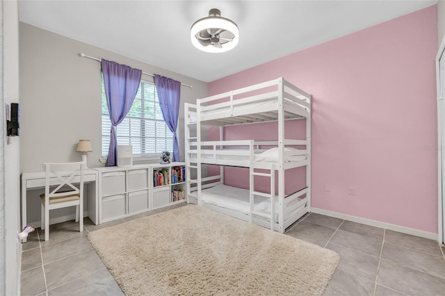 tiled bedroom featuring baseboards