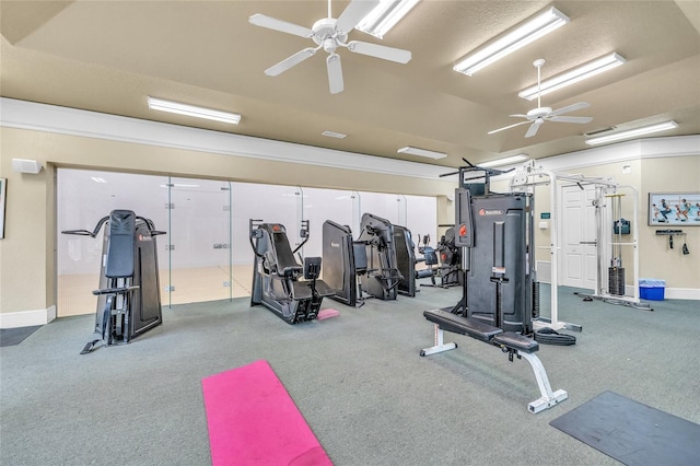 exercise room with baseboards and a ceiling fan