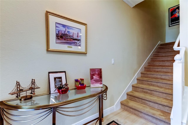 stairway with baseboards and wood finished floors