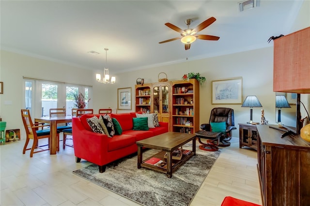 living room featuring visible vents, crown molding, and ceiling fan with notable chandelier