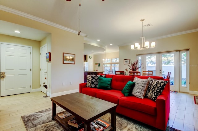 living room featuring french doors, crown molding, a notable chandelier, visible vents, and baseboards