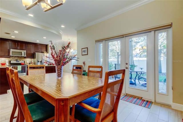 dining space with recessed lighting, french doors, visible vents, and crown molding