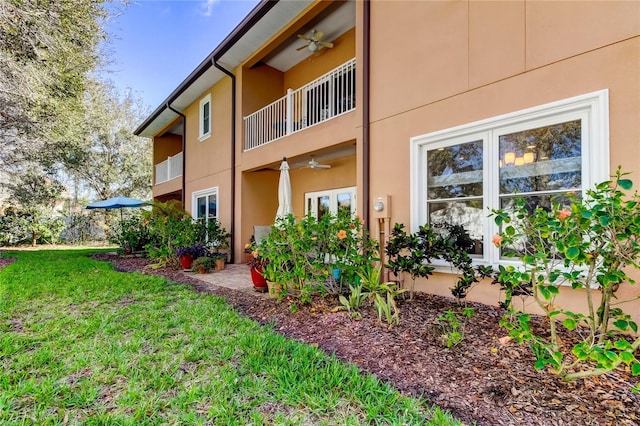 exterior space featuring ceiling fan and a balcony