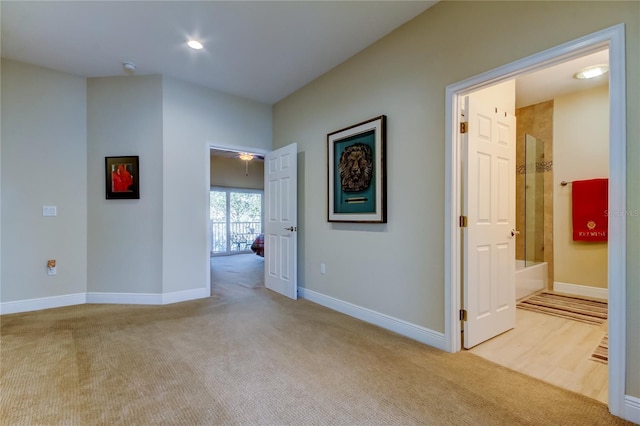 corridor with recessed lighting, baseboards, and light colored carpet