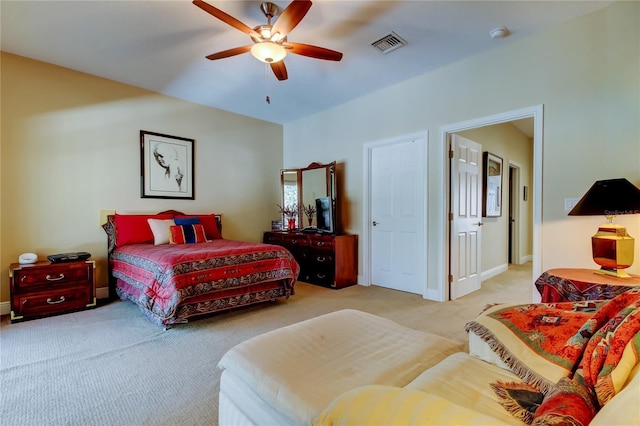 bedroom featuring light colored carpet, visible vents, ceiling fan, and baseboards