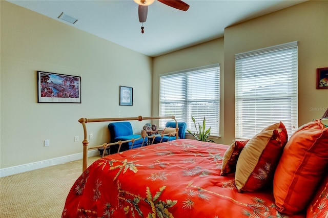 bedroom featuring ceiling fan, carpet flooring, visible vents, and baseboards