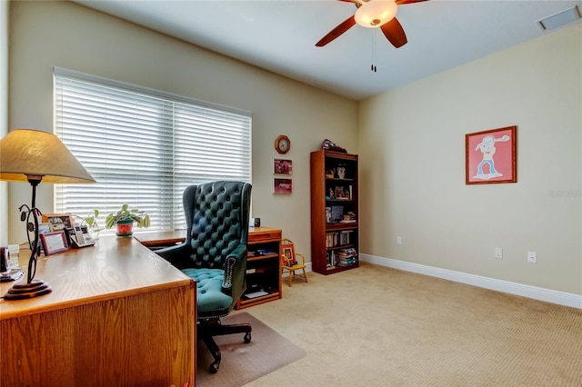 office featuring light carpet, ceiling fan, visible vents, and baseboards