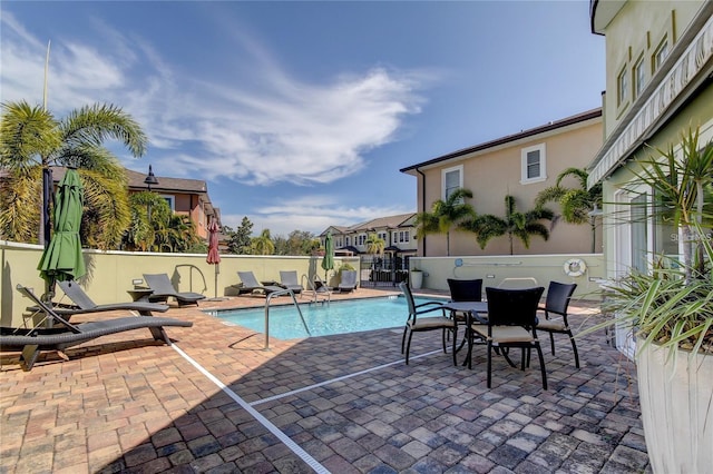 view of pool featuring a patio area, fence, and a fenced in pool