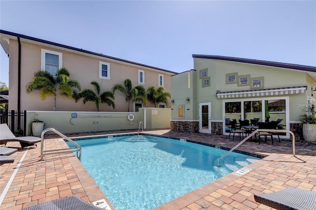 pool with fence and a patio