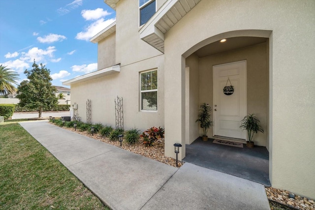 doorway to property with stucco siding