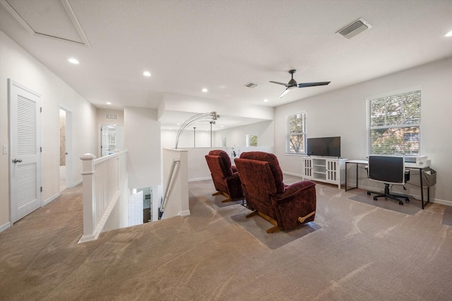 living area featuring recessed lighting, visible vents, and light carpet