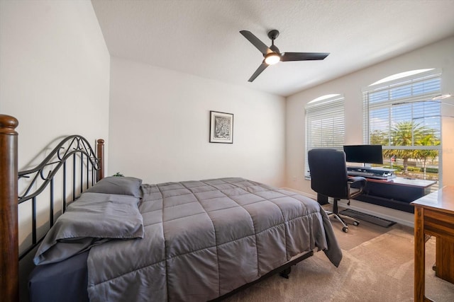 carpeted bedroom with a textured ceiling and ceiling fan