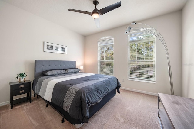 carpeted bedroom featuring ceiling fan and baseboards