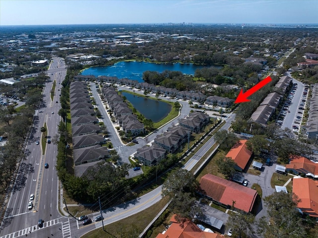 birds eye view of property with a water view and a residential view