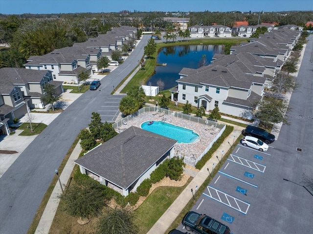 drone / aerial view with a water view and a residential view