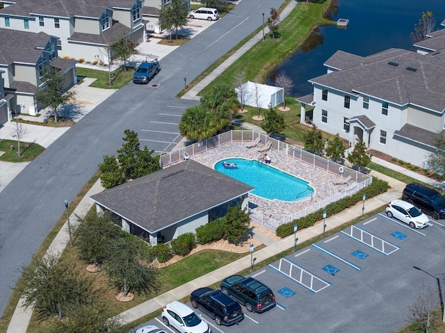 drone / aerial view featuring a water view and a residential view