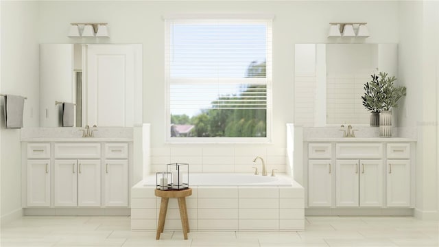 bathroom with vanity and tiled tub