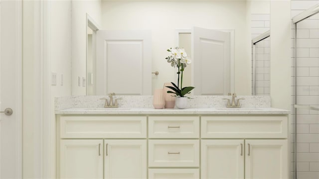 bathroom with a shower with shower door and vanity