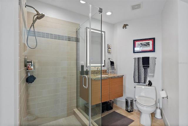 bathroom featuring visible vents, toilet, a stall shower, vanity, and tile patterned flooring