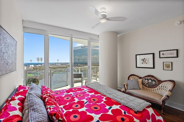 bedroom featuring access to exterior, ceiling fan, baseboards, and wood finished floors