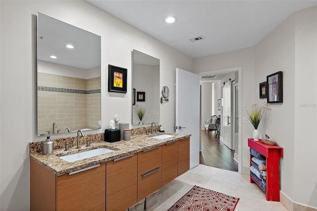 full bath with recessed lighting, visible vents, a sink, and double vanity