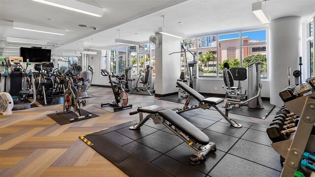 workout area with carpet flooring, plenty of natural light, and baseboards