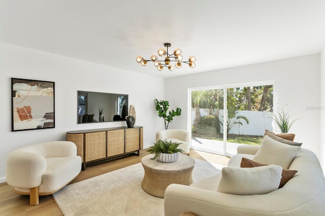 living area featuring an inviting chandelier and light wood-style flooring