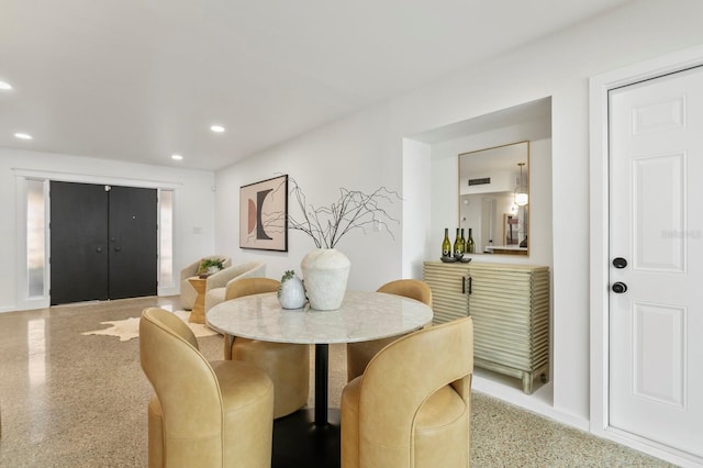 dining space featuring recessed lighting and speckled floor