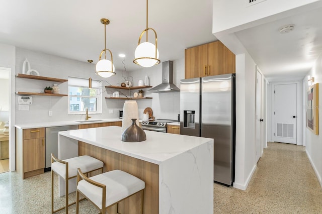 kitchen featuring open shelves, a sink, appliances with stainless steel finishes, wall chimney range hood, and light speckled floor