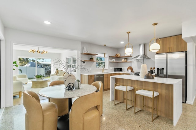 kitchen with open shelves, a sink, stainless steel appliances, wall chimney range hood, and modern cabinets