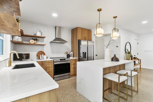 kitchen with open shelves, stainless steel appliances, light speckled floor, wall chimney exhaust hood, and a sink