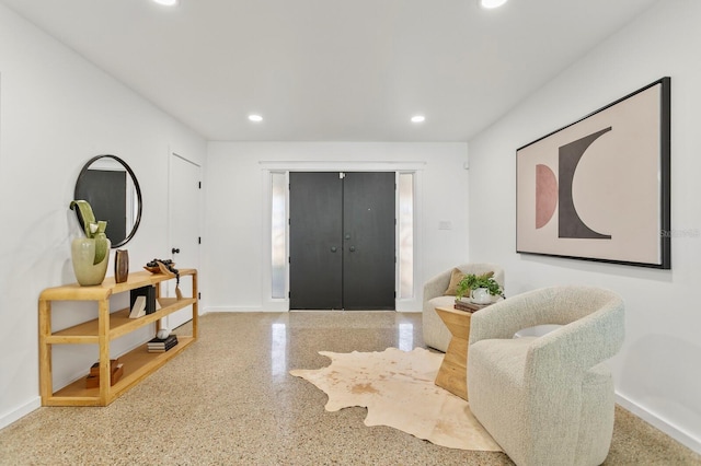 foyer featuring recessed lighting, speckled floor, and baseboards