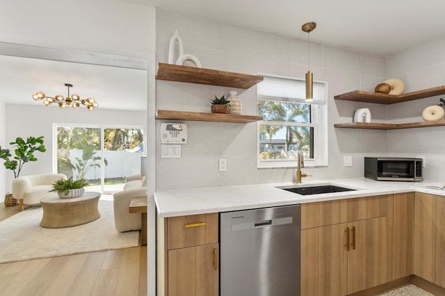 kitchen with a sink, plenty of natural light, appliances with stainless steel finishes, and open shelves