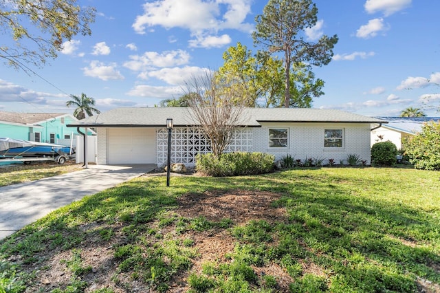 ranch-style house with brick siding, an attached garage, concrete driveway, and a front yard