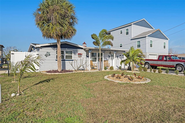 view of front of home with a garage and a front lawn