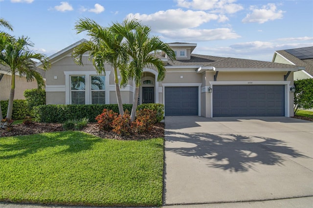 view of front of home with stucco siding, a shingled roof, concrete driveway, a front yard, and a garage