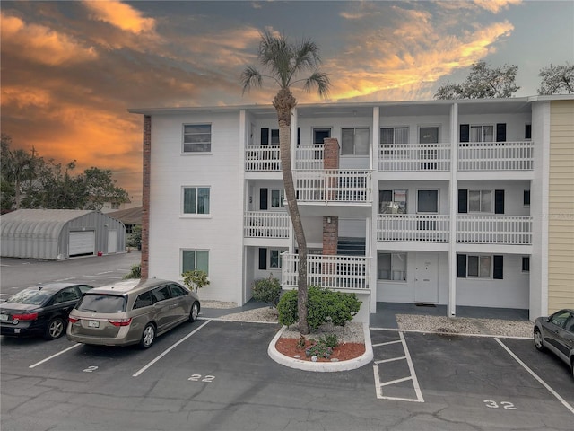 property at dusk featuring uncovered parking