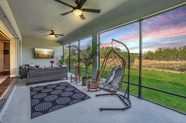 sunroom featuring an outdoor hangout area and a ceiling fan