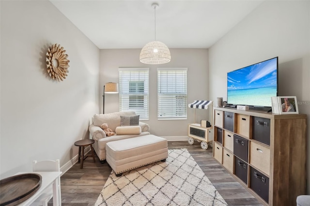 living area with baseboards and dark wood-style floors