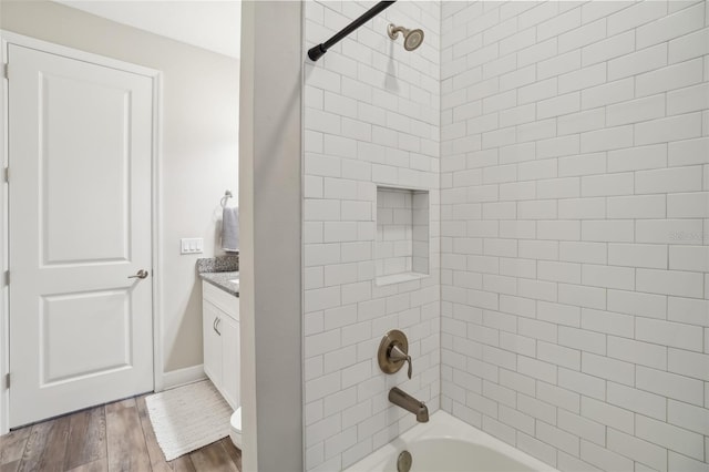bathroom featuring wood finished floors, shower / bath combination, vanity, and toilet