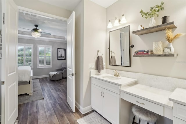 bathroom featuring ensuite bathroom, baseboards, a ceiling fan, wood finished floors, and vanity