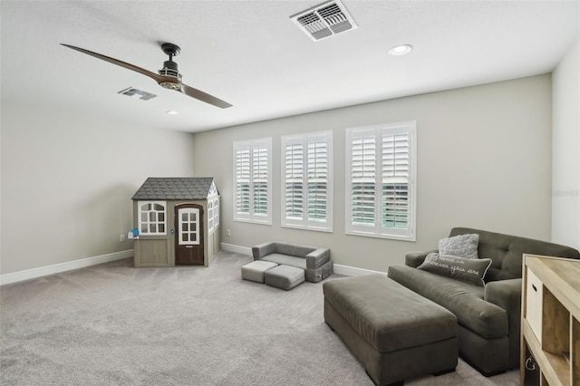 sitting room with baseboards, a ceiling fan, visible vents, and carpet floors