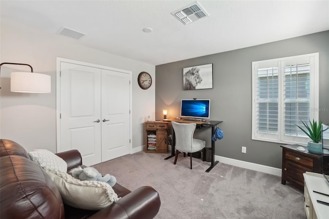 office space with carpet floors, visible vents, and baseboards
