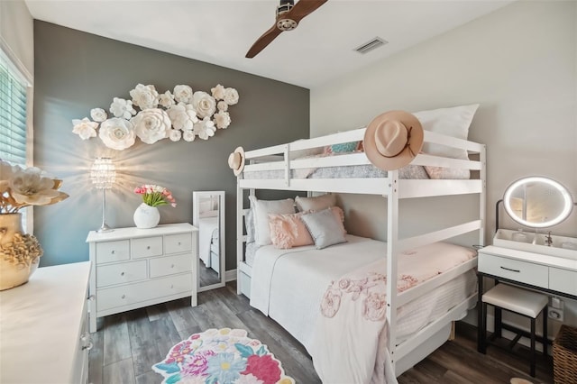 bedroom with wood finished floors, visible vents, and a ceiling fan