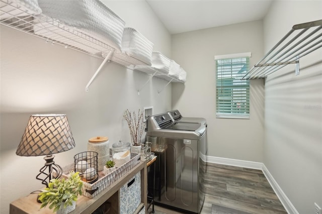 laundry room with baseboards, wood finished floors, independent washer and dryer, and laundry area