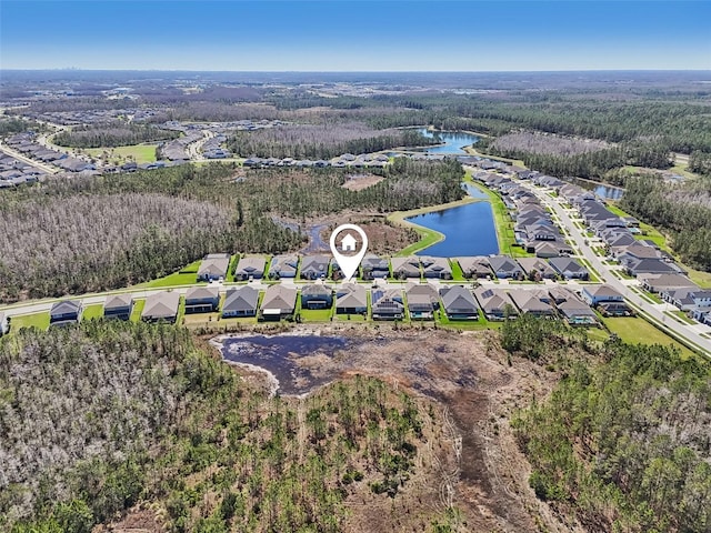 aerial view featuring a forest view, a water view, and a residential view