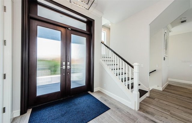 entryway with french doors and wood-type flooring