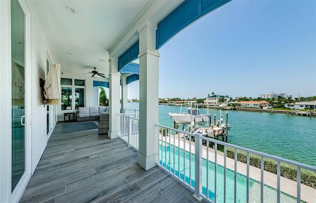 balcony with ceiling fan and a dock